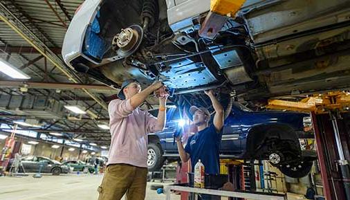 Students working on a vehicle in the automotive lab